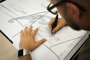 Hand-drawn fashion design sketches on paper
