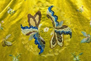 Gold thread embroidery on red fabric