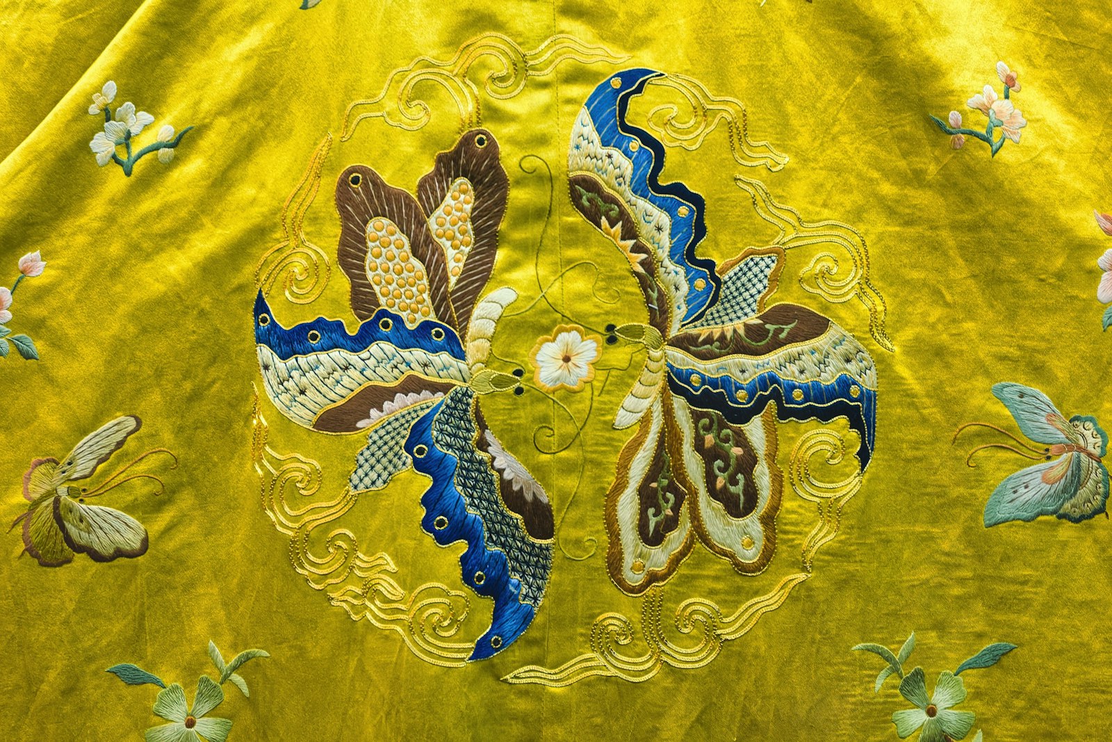 Gold thread embroidery on red fabric