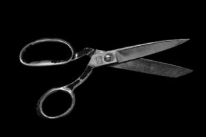 Scissors cutting fabric on a tailor's table